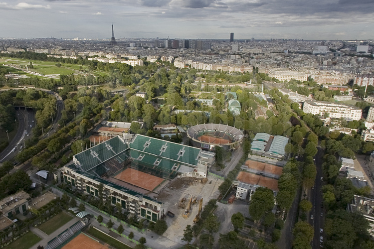 Vue du XVIème arrondissement avec, au premier plan (de g. à d.), le stade Roland Garros et le boulevard d'Auteuil. Au second plan (de g. à d.), l'hippodrome d'Auteuil et les serres d'Auteuil. En arrière plan (de g. à d.), la butte Montmartre, la Tour Eiffel, le Front de Seine, la Tour Montparnasse et le XVIème arrondissement. Altitude 110 mètres.