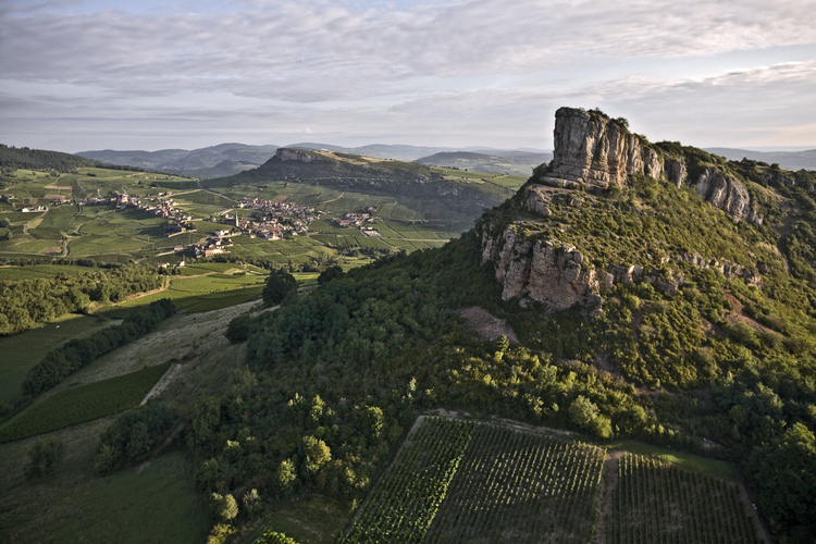 Vue générale de la Roche de Solutré (qui culmine à 493 mètres) au printemps. C'est un des plus riches gisements préhistorique d'Europe. En arrière plan, la roche de Vergisson.