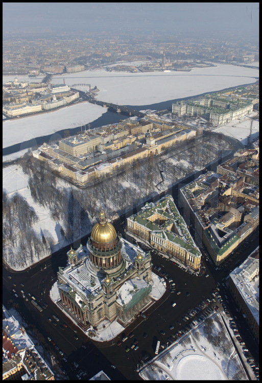 Aerial view of Saint Isaac's Cathedral, the third largest baroque 
cathedral in Europe after Rome's Saint Peter and London's St Paul ( 300 000 
tons, 4 000m2, 101 meters high).  Built by French architect Auguste de 
Montferrand, it was inaugurated in 1858.  In the middle, from left to right, 
the Admiralty and the Winter Palace.  In the background, the Strelka (the 
tip) of Vassilievski Island with the Academy of Sciences, the Kounskamera, 
the Marine Museum, the Rostral Columns, the Peter and Paul Fortress, and 
Petrograd, the city's first neighborhood founded in 1703.  The cathedral's 
dome, visible from every place in the city, required 100 kilos of gold to 
cover it.