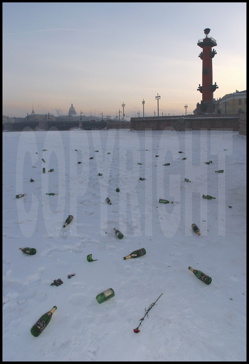 In front of the Strelka (the tip) of Vassilievski Island, St Petersburg's 
young married couples celebrate their union on the frozen Neva.  The numerous 
champagne bottles strewn across the ice show the vitality of this tradition.  
In the background, the Palace banks with, from left to right, the Admiralty, 
Saint Isaac's Cathedral, the Dvortsovy Bridge, and one of the Rostral Columns 
which originally served as a lighthouse to boats entering the port.