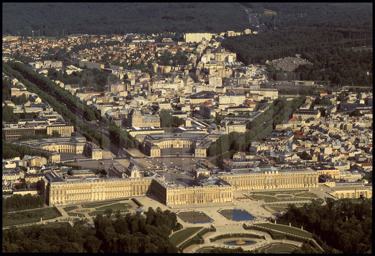 Vue générale du domaine de Versailles. Au premier plan, le Château et une partie des jardins. En arrière plan, le centre ville historique de la ville et la forêt de Fausse-Reposes.