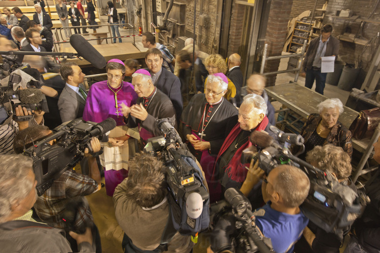 Asten, Netherlands. Royal Eijsbouts foundry, 14 September 2012. This is the day of casting big bell Mary (note G sharp, 6200 kg). On this occasion, three bishops, the rector Archpriest of Notre Dame and many journalists came to bless and celebrate the birth of the new bell. From left to right: Bishop Eric de Moulins-Beaufort, auxiliary Bishop of Paris, the bishop of Asten, the birthcity of bell foundry, the bishop of the neighboring diocese of Hasselt, Belgium, and Mgr Patrick Jacquin, Rector archpriest of Notre Dame de Paris.