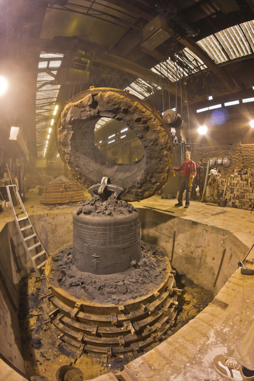 Asten, Netherlands. Royal Eijsbouts foundry, 24 September 2012. Ten days after casting, the big bell Marie (note G sharp, 6200 kg), in which the metal is still hot, is unmolded by Wim Hurkmans, head of the foundry workshop.