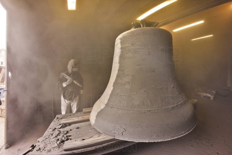 Asten, Netherlands. Royal Eijsbouts foundry, 24 September 2012. Ten days after casting, the big bell Marie (note G sharp, 6200 kg), in which the metal is still hot, is the subject of a first pickling in a room intended this purpose, away from the main workshop.