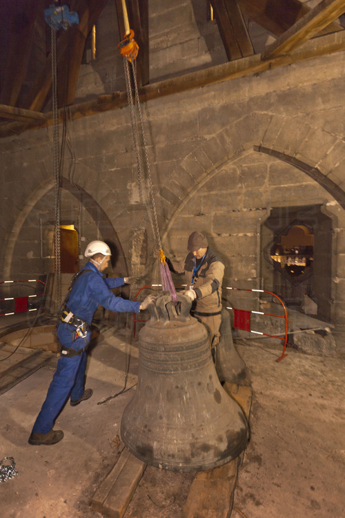 Notre Dame de Paris, 17 February 2012. The four ancient bells, hung 45 meters high in the north tower, are filed one after the other. Once unhooked, they are descended to the ground carefully, through a succession of loculis, built for this purpose at the time of the Middle Ages. Started at 4pm, the operation ends at 9pm.