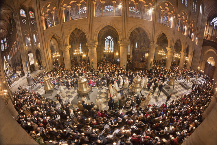 February 2, 2013: Baptism of bells in the cathedral of Notre Dame. Here, the new bells aligned in the nave, surrounded by the crowd. Center, Cardinal André Vingt Trois (miter), archbishop of Paris and Patrick Jacquin, Archpriest-Rector of Notre Dame, who preside over the baptism ceremony of each bell.
