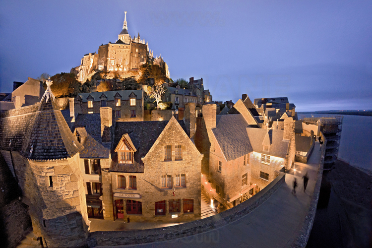 At dusk, south of Mont Saint Michel, street of Remparts. In the background, the church.