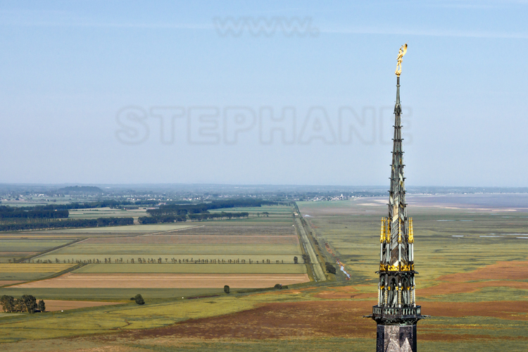 Surmounted by the statue of the Archangel Michael, the spire of the abbey of Mont Saint Michel as seen from the east.