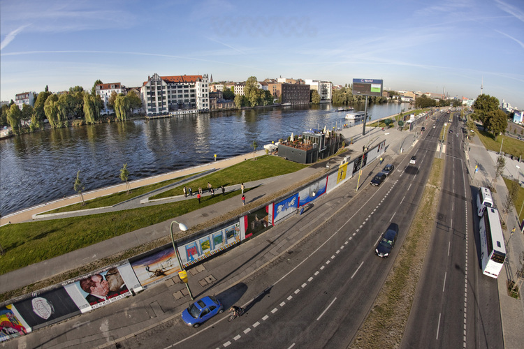 The East Side Gallery. Located on the Mühlenstrasse in the Friedrichshain district is the largest segment of wall preserved. 1300 meters long and historic monument in 1992, it has also become the largest open air gallery in the world. Before 1989, the wall was white and gray, a barrier prevented from approaching or touching. The entire river, which acted as a 