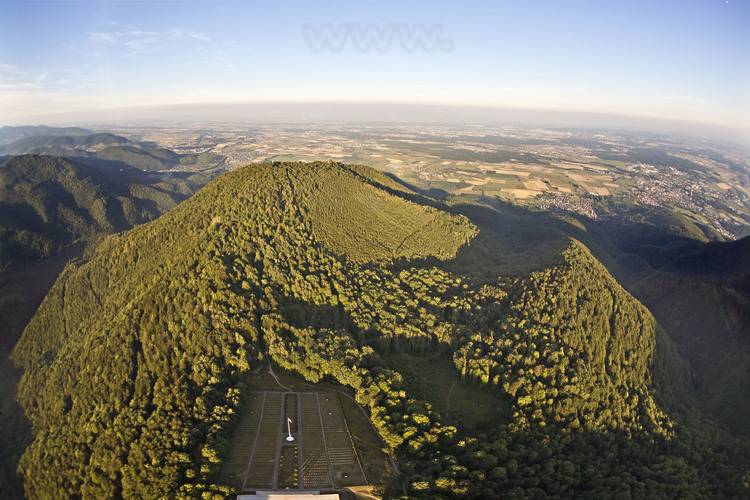 Battle of Hartmanswillerkopf (Hill of the Old Armand): General aerial view of the site. At the top of the hill, the ridge where was situated the front line. In the foreground, the National Cemetery (one of the four with those of Notre Dame de Lorette, Dormans and Douaumont). On the background, the plain of Alsace, at the time German. From this strategic position overlooking the south of the plain of Alsace (east of the Vosges remained French), about 300,000 men fought here to win (for French) or defend (for German) Alsace region. Approximately 50,000 people are dead or missing and 12,000 French soldiers are buried unknown in the crypt of the National Monument (pictures 239 and 240).