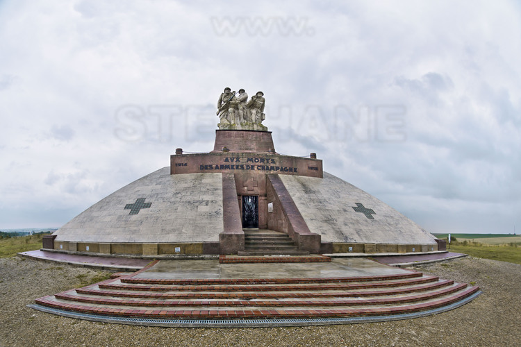Battles of Champagne: Monument of battles of Champagne, on the former site of Navarin farm. Located in the center of the Champagne front, which stretched from Reims to Argonne, and erected on the initiative of General Gouraud, the monument commemorates the battles from September 1914 to October 1918. The surrounding land still bears the scars of battles with trenches, hoses, craters, etc. The crypt houses the remains of 10,000 soldiers, most of whom are anonymous. At the summit, a group of three stone statues by sculptor Real del Sarte, which represents three soldiers in combat with, from left to right: brother of the sculptor, who was killed in Champagne, General Gouraud himself and Quentin Roosevelt, nephew of President Theodore Roosevelt, who died in France on 14 July 1918 near Cambrai.