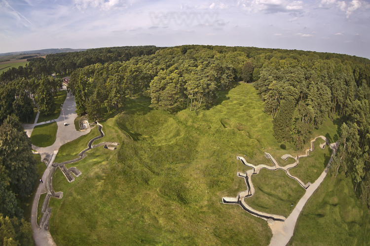 Battle of Artois: Vimy Ridge, Canadian National Historic Site. The no man's land of the front line (center), is still riddled with craters due to mine warfare and shrapnel. Left, the trenches of the first Allied lines. Right, the first German trench lines. Between the two, about 25 meters. After an assault launched on 9 April 1917, the troops with the maple leaf, met for the first time in a non British single corps, wins Vimy Ridge, marking a major chapter in the history of the Canadian nation. The Vimy ridge is forested today (background): Each tree was planted by a Canadian and symbolizes the sacrifice of a soldier.