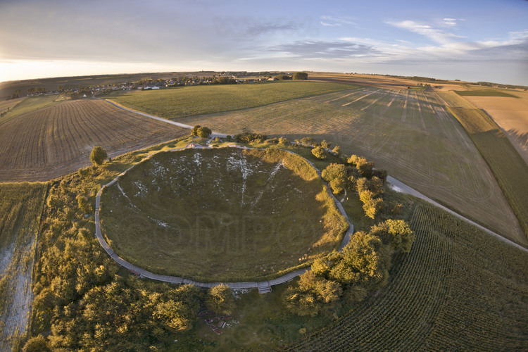 Battle of the Somme : Lochnanar Crater (Big Mine), close to village of La Boiselle. The mine exploded on July 1, 1916 at 7:28 am, marking the beginning of the Battle of the Somme. That day, the men jumped from their positions ignoring they rushed towards imminent death caused by their own camp : for a few minutes before the infantry assault, several huge explosions triggered by the allies and intended to break the German front lines, dug deep craters such as this borehole, which is 100 meters in diameter and 30 meters deep, and currently the only accessible to public. The beginning of the Battle of the Somme was the scene of a terrible carnage : 58000 men killed or wounded in the first day. Four months later, the result is terrible : 1200000 men put out of action for a total of 3000000 men. It was the British, with about 420,000 dead, wounded, missing and prisoners on the only sector of the Somme, who pay the heaviest tribe to slaughter, and 1st July 1916 was the worst day of their entire military history. Every July 1st at 7:28 am, the British hold a ceremony around this crater : in its bottom are deposited thousands of poppies. There are 410 British cemeteries in the Somme.