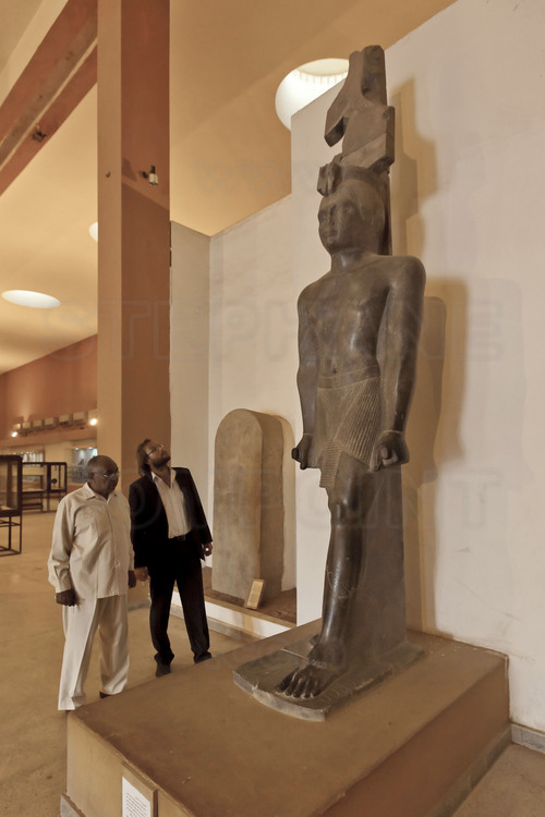Mr. Ahmed Babiker Nihar, Minister of Antiquities and Tourism (left) makes a tour of the National Museum in Khartoum to Menno Welling, from ICOMOS. In the foreground, a colossal statue of King Taharqa (690-664 AD), the sixth king of the 25th dynasty.