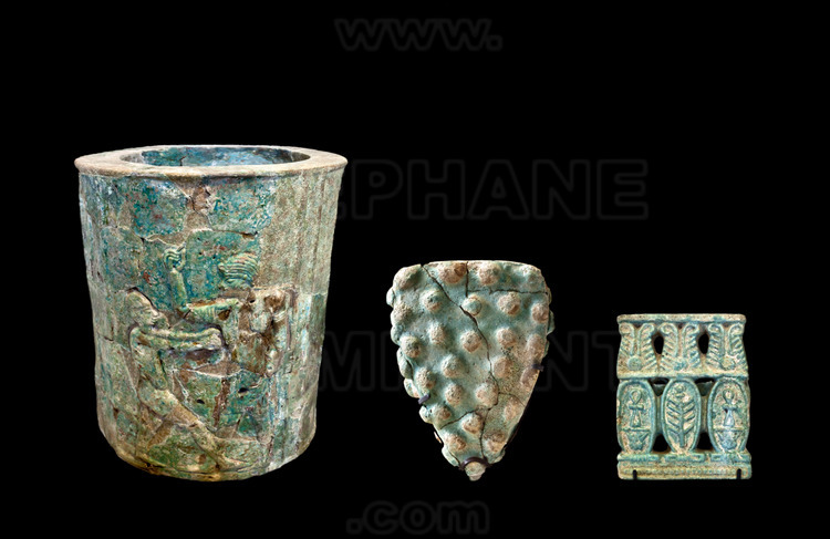 Objects and decorative elements found on archaeological sites of Meroe. On the left, a column drum decorated with scenes of dancing and music. In the center, an architectural decoration in the shape of grapes. At right, a seal.