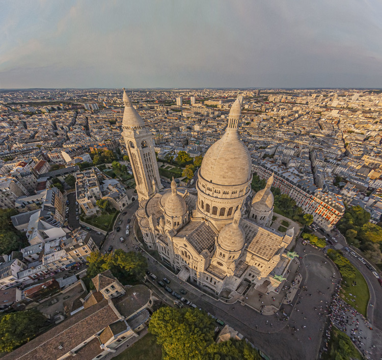 Paris (75) - La butte Montmartre et la basilique du Sacré Coeur vus depuis le Sud Est. Située au sommet de la butte Montmartre, la basilique du Sacré-Cœur, est l'un des édifices religieux majeurs de Paris. Sa construction est décidée en 1870 (juste après la guerre franco-allemande) lors du vœu national d'Alexandre Legentil et Hubert Rohault de Fleury, et sera achevée en 1914. Sa situation à 130 m d'altitude près de l'un des points culminants de Paris, et son dôme qui s'élève à 83 mètres, la rendent visible de très loin. Avec près de onze millions de pèlerins et visiteurs par an, c'est le deuxième monument religieux parisien le plus visité après la cathédrale Notre-Dame de Paris. // France - Paris (75) - The Montmartre hill and the Sacré Coeur basilica seen from the South East. Located at the top of the Montmartre hill, the Sacré-Coeur basilica is one of the major religious buildings in Paris. Its construction was decided in 1870 (just after the Franco-German war) during the national wish of Alexandre Legentil and Hubert Rohault de Fleury, and will be completed in 1914. Its location at 130 m above sea level near one of the points highlights of Paris, and its dome which rises to 83 meters, make it visible from far away. With nearly eleven million pilgrims and visitors a year, it is the second most visited Parisian religious monument after Notre-Dame de Paris cathedral.