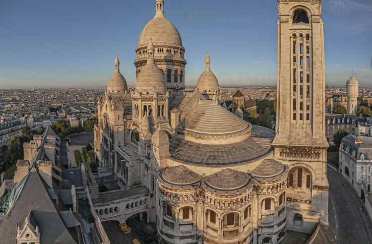 Paris (75) - la basilique du Sacré Coeur vue depuis le Nord. Située au sommet de la butte Montmartre, la basilique du Sacré-Cœur, est l'un des édifices religieux majeurs de Paris. Sa construction est décidée en 1870 (juste après la guerre franco-allemande) lors du vœu national d'Alexandre Legentil et Hubert Rohault de Fleury, et sera achevée en 1914. Sa situation à 130 m d'altitude près de l'un des points culminants de Paris, et son dôme qui s'élève à 83 mètres, la rendent visible de très loin. Avec près de onze millions de pèlerins et visiteurs par an, c'est le deuxième monument religieux parisien le plus visité après la cathédrale Notre-Dame de Paris. // France - Paris (75) - the Sacré Coeur basilica seen from the North. Located at the top of the Montmartre hill, the Sacré-Coeur basilica is one of the major religious buildings in Paris. Its construction was decided in 1870 (just after the Franco-German war) during the national wish of Alexandre Legentil and Hubert Rohault de Fleury, and will be completed in 1914. Its location at 130 m above sea level near one of the points highlights of Paris, and its dome which rises to 83 meters, make it visible from far away. With nearly eleven million pilgrims and visitors a year, it is the second most visited Parisian religious monument after Notre-Dame de Paris cathedral.