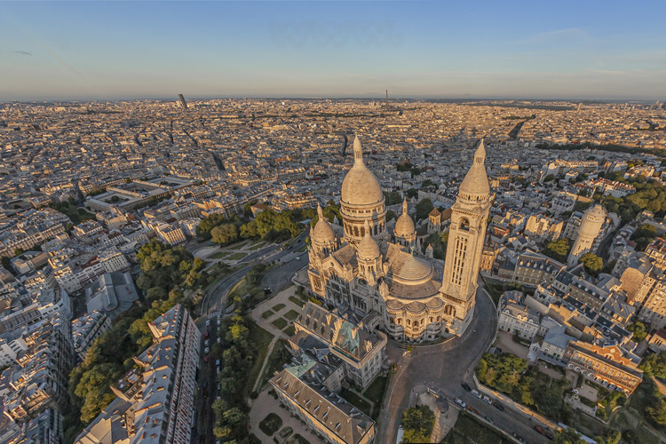 Paris (75) - La butte Montmartre et la basilique du Sacré Coeur vus depuis le Nord. En arrière plan de gauche à droite, la Tour Montparnasse et la Tour Eiffel. Située au sommet de la butte Montmartre, la basilique du Sacré-Cœur, est l'un des édifices religieux majeurs de Paris. Sa construction est décidée en 1870 (juste après la guerre franco-allemande) lors du vœu national d'Alexandre Legentil et Hubert Rohault de Fleury, et sera achevée en 1914. Sa situation à 130 m d'altitude près de l'un des points culminants de Paris, et son dôme qui s'élève à 83 mètres, la rendent visible de très loin. Avec près de onze millions de pèlerins et visiteurs par an, c'est le deuxième monument religieux parisien le plus visité après la cathédrale Notre-Dame de Paris. // France - Paris (75) - The Butte Montmartre and the Sacré Coeur Basilica seen from the North. In the background from left to right, the Montparnasse Tower and the Eiffel Tower. Located at the top of the Montmartre hill, the Sacré-Coeur basilica is one of the major religious buildings in Paris. Its construction was decided in 1870 (just after the Franco-German war) during the national wish of Alexandre Legentil and Hubert Rohault de Fleury, and will be completed in 1914. Its location at 130 m above sea level near one of the points highlights of Paris, and its dome which rises to 83 meters, make it visible from far away. With nearly eleven million pilgrims and visitors a year, it is the second most visited Parisian religious monument after Notre-Dame de Paris cathedral.