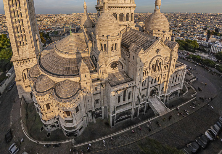 Paris (75) - La basilique du Sacré Coeur vue depuis le Sud Ouest. Située au sommet de la butte Montmartre, la basilique du Sacré-Cœur, est l'un des édifices religieux majeurs de Paris. Sa construction est décidée en 1870 (juste après la guerre franco-allemande) lors du vœu national d'Alexandre Legentil et Hubert Rohault de Fleury, et sera achevée en 1914. Sa situation à 130 m d'altitude près de l'un des points culminants de Paris, et son dôme qui s'élève à 83 mètres, la rendent visible de très loin. Avec près de onze millions de pèlerins et visiteurs par an, c'est le deuxième monument religieux parisien le plus visité après la cathédrale Notre-Dame de Paris. // France - Paris (75) - The Sacré Coeur basilica seen from the South West. Located at the top of the Montmartre hill, the Sacré-Coeur basilica is one of the major religious buildings in Paris. Its construction was decided in 1870 (just after the Franco-German war) during the national wish of Alexandre Legentil and Hubert Rohault de Fleury, and will be completed in 1914. Its location at 130 m above sea level near one of the points highlights of Paris, and its dome which rises to 83 meters, make it visible from far away. With nearly eleven million pilgrims and visitors a year, it is the second most visited Parisian religious monument after Notre-Dame de Paris cathedral.