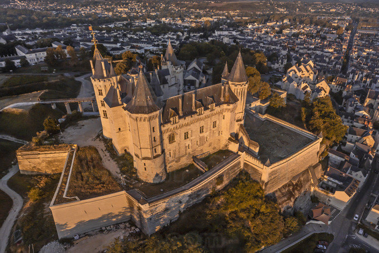 Val de Loire - Maine et Loire (49) - Château de Saumur : Vue aérienne depuis l'est au soleil levant. Tout autour, la ville de Saumur. Reconstruit par René d'Anjou (1409 - 1480) et seul palais princier subsistant en France, il figure dans les célèbres 