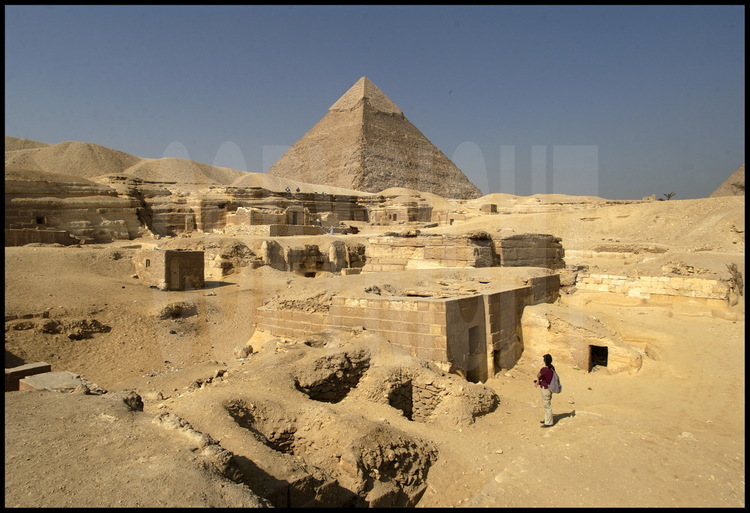 Dans la partie sud de la nécropole de Gizeh, le monument funéraire de Kuenthawes entourés de tombes de dignitaires de l’ancien empire. En arrière plan, la pyramide de Khephren (IVème dynastie).