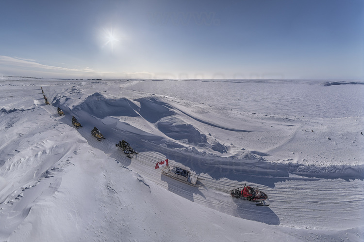 Canada - State of Nunavut - Operation NUNALIVUT 2018 - Surroundings of Cambridge Bay - Led by Jimmy Evalik, 59, Ranger Chief of the Cambridge Bay area, the snowmobile patrol heads to the planned location for the survival camp No. 2. In the background, the icy waters of the Northwest Passage.
