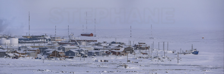 Canada - State of Nunavut - Operation Nunalivut 2018 - Southern part of the village of Cambridge Bay (1700 inhabitants), the main community on the Northwest Passage. On the right, the scientific boat Martin Bergmann, caught in the ice of the North West Passage.
